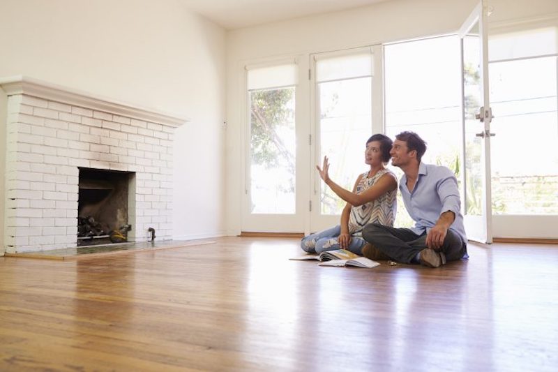 Excited Couple Planning Decoration Of New Home